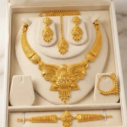 Gold necklace set with earrings and bracelet in a display box